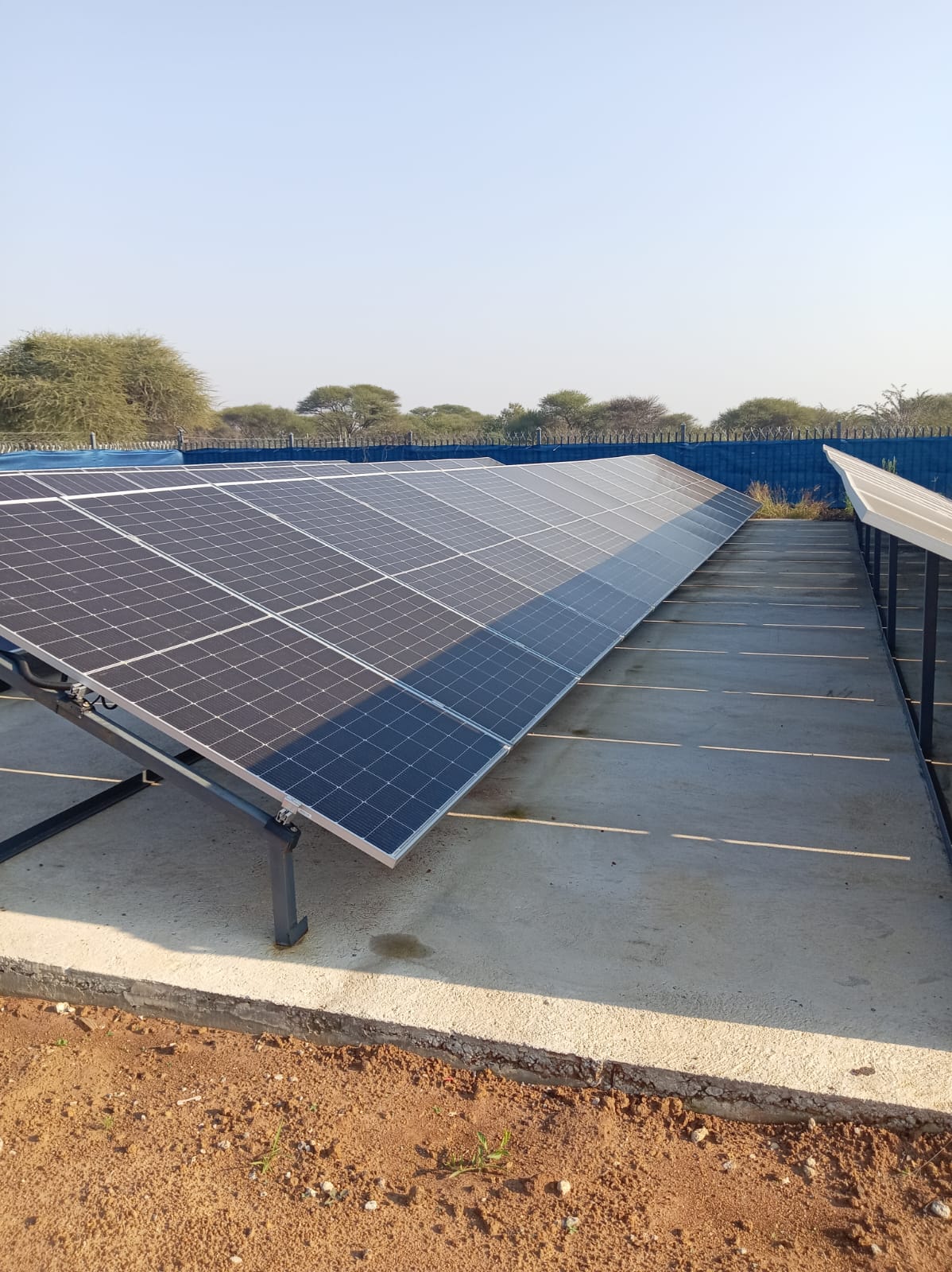 Large-scale ground-mounted solar PV array — rows of polycrystalline panels on steel racking, Gauteng
