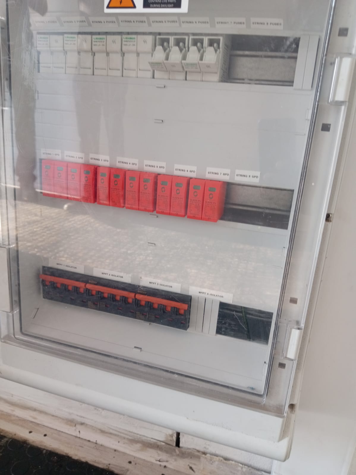 8-string DC solar combiner panel with red surge protective devices and MPPT isolator switches in weatherproof enclosure