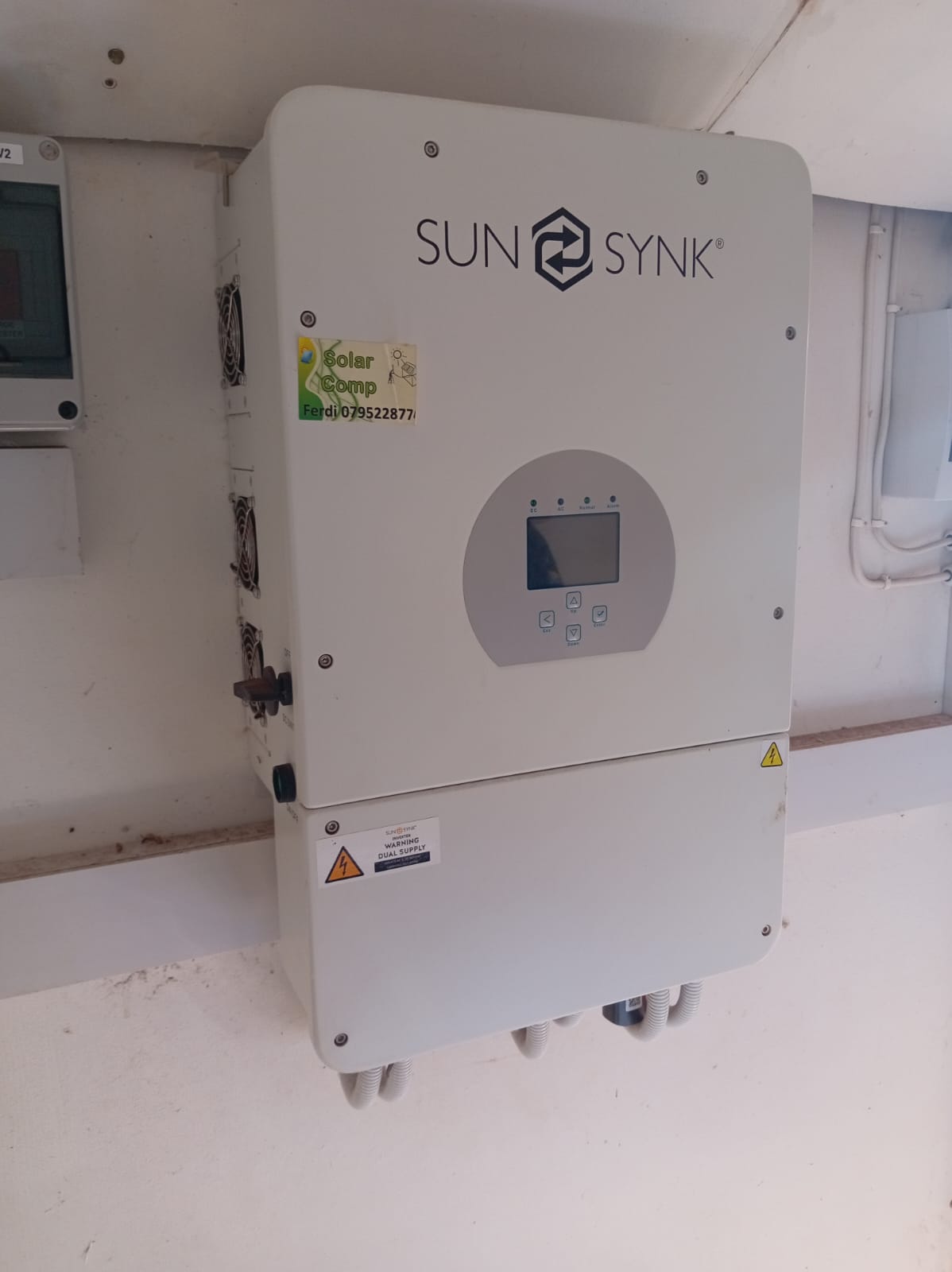 Sunsynk large-format hybrid inverter with dual PV switch inputs and WiFi module in utility room